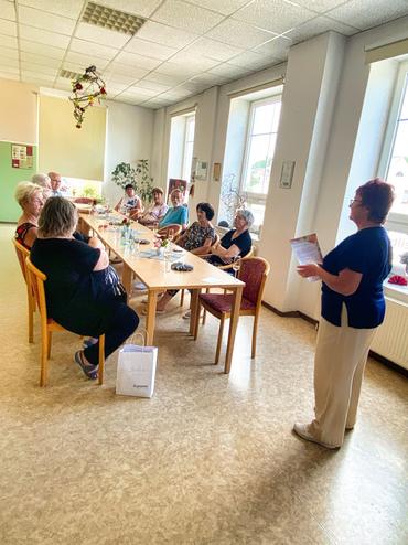 Auf dem Bild ist Frau Radke vor Publikum zu sehen. Sie hält ihren Vortrag über die Speisekarten.